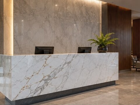 Building lobby with marble reception desk and backlit marble feature wall