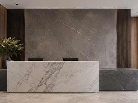 Office lobby reception desk in white marble against a gray stone slab feature wall
