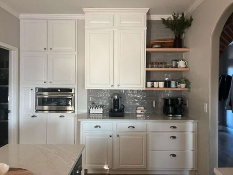 Custom built-in coffee station with quartz counter and open wood shelving